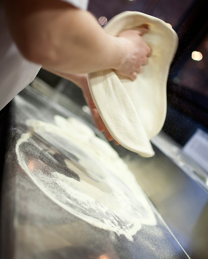 Preparing pizza base